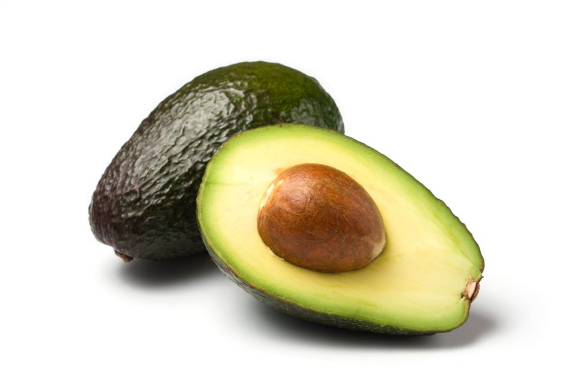 whole and half avocado isolated on white